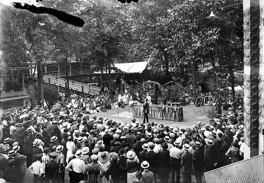 In addition to acts provided by colony members, the House of David brought in various acts from the outside world. This photograph shows a crowd enthralled by an exotic bird show.