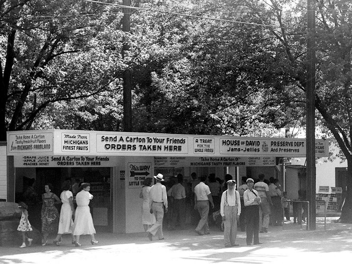 When you walked from our free parking lot, one of the first buildings on the South side was the Jam and Jelly Stand.  Oscar and Agnes (Dalager) Wade used to run this stand at the North end of the park.  Later it was manned by Violet (McFarlane) Tucker and former member Reuben Jeffery.
