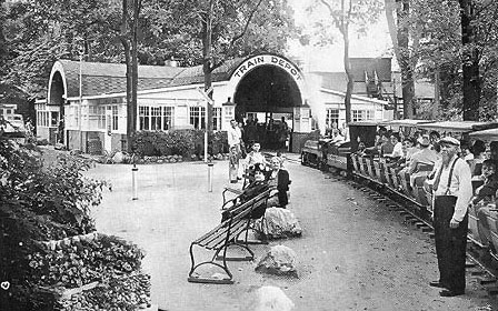 The south depot was the arrival point for most visitors to the park.  The depot was ringed by cottages, a baseball park, zoo, restaurant and hotel.  Inside the depot were souvenir stands and an ice cream parlor.  On the east side of the depot was a hopper and water tank for the replenishment of coal and water for the miniature engines.  Once refueled the trains would depart on their return trip through the zoo, over the east trestle, past more tourist cabins and the Diamond House to the north depot on Britain Ave.  Update: As it appeared in 2001.