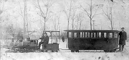 To honor founders Mary and Benjamin, colony members constructed an enclosed passenger car for their privacy and protection from the elements when riding on the trains.  This car was rarely used and only in the early years.  Because of the narrow gauge tracks and the heavy superstructure of this car it was unstable and could only be run on the curves at slow speed.  An interesting feature of this image is a rare glimpse just above the front of the locomotive of the park dance pavilion that would later become a roundhouse.
